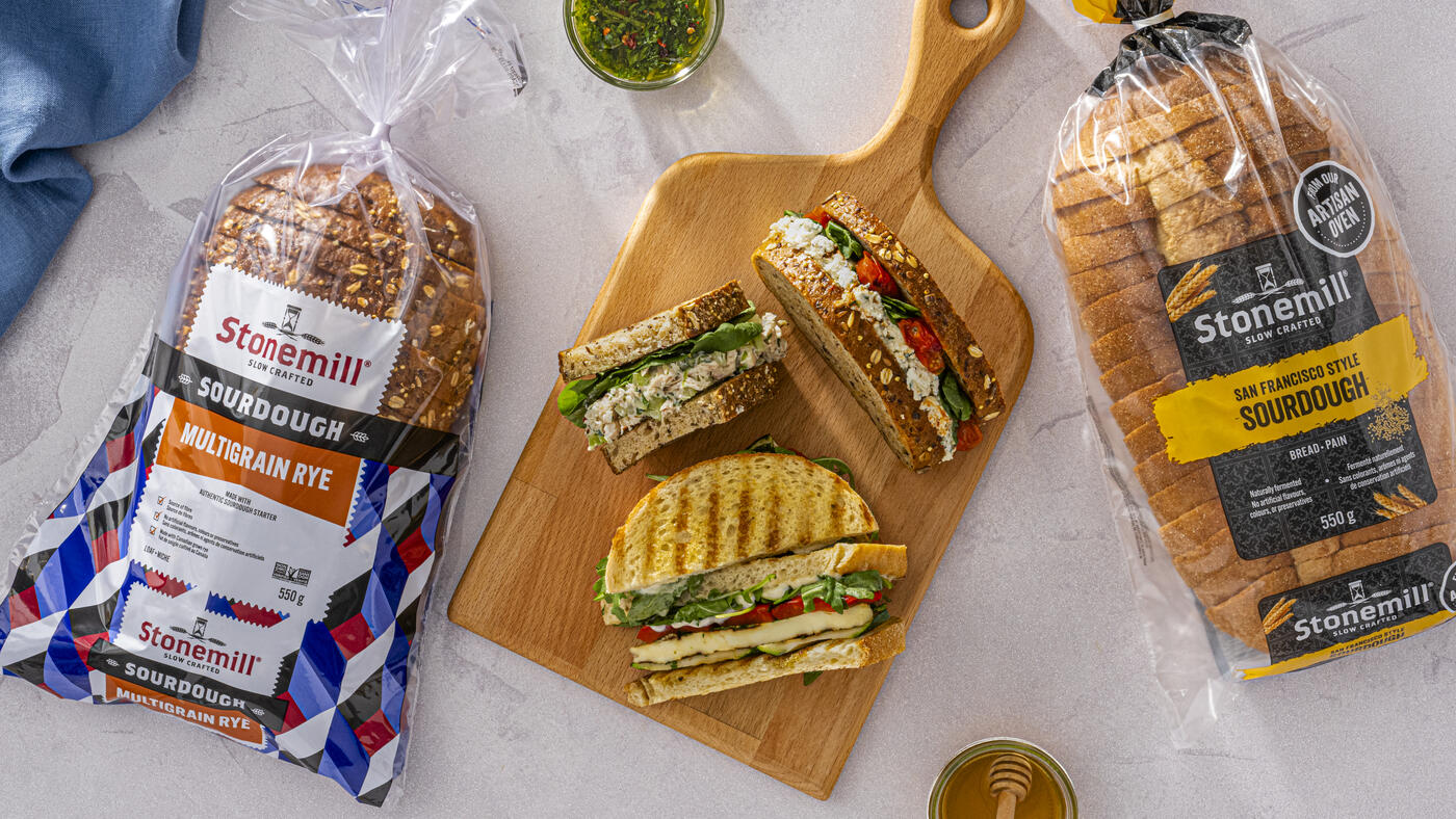 Recipe Hero - Sandwiches atop a cutting board and packages of Stonemill Bread on the sides